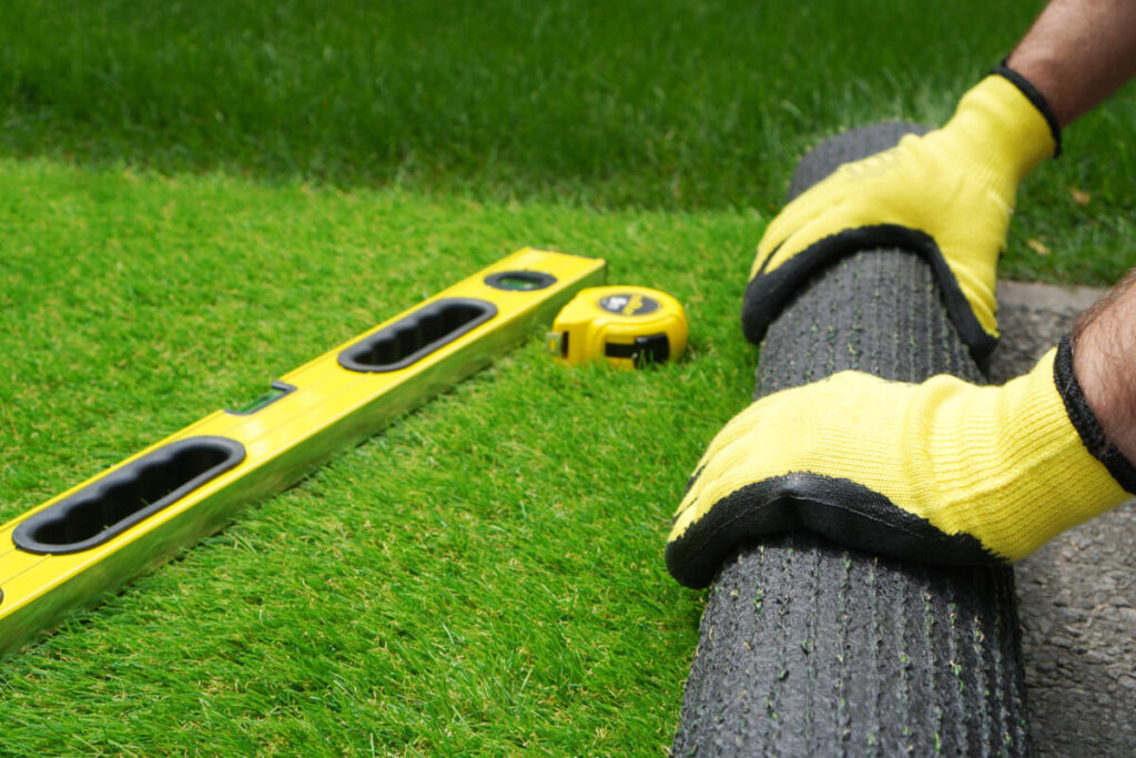 person installing artificial grass