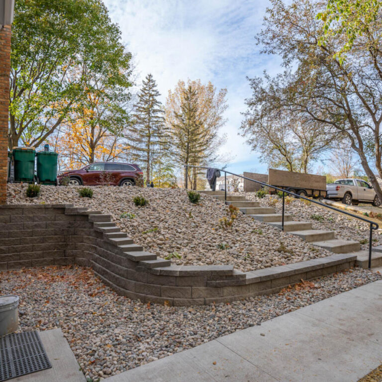 brick retaining wall with river rock cover